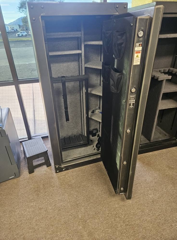 Open gun safe with rifle racks on the showroom floor